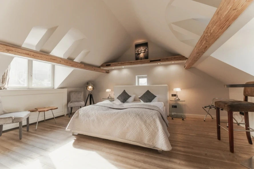 Apartment in Heidelberg's old town by BS Suites, with large double bed, sloped ceiling, and chairs